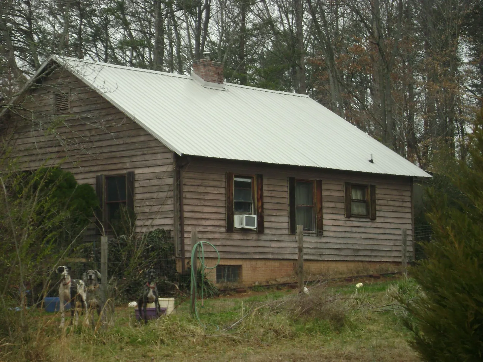 White metal roof on an old wood sided farmhouse, from a Metal Roof Installation job in Warrensville